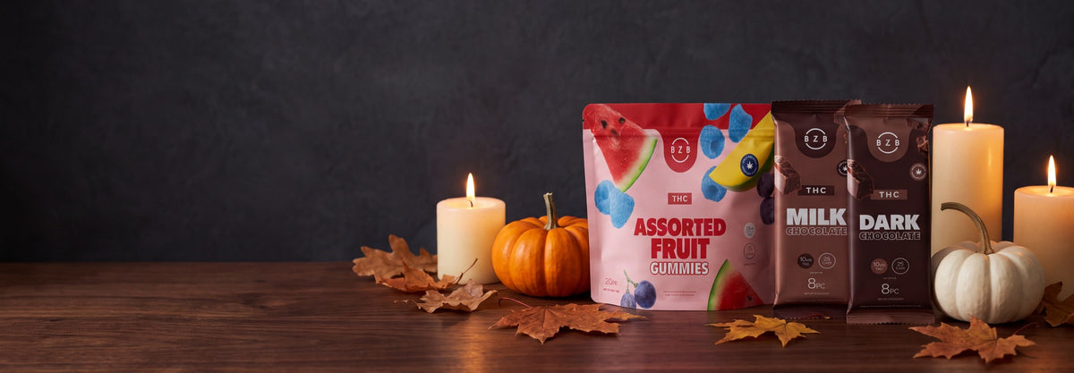 beeZbee Delta-9 THC Assorted Fruit Gummies with Milk and Dark Chocolate bars among pumpkins and candles