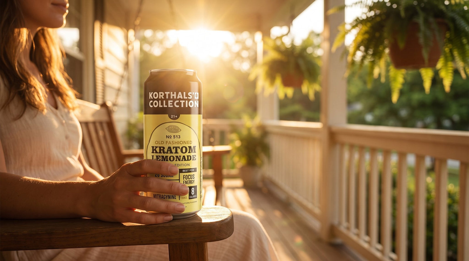 Woman holding No. 513 Kratom Old Fashioned Lemonade on a golden-hour porch